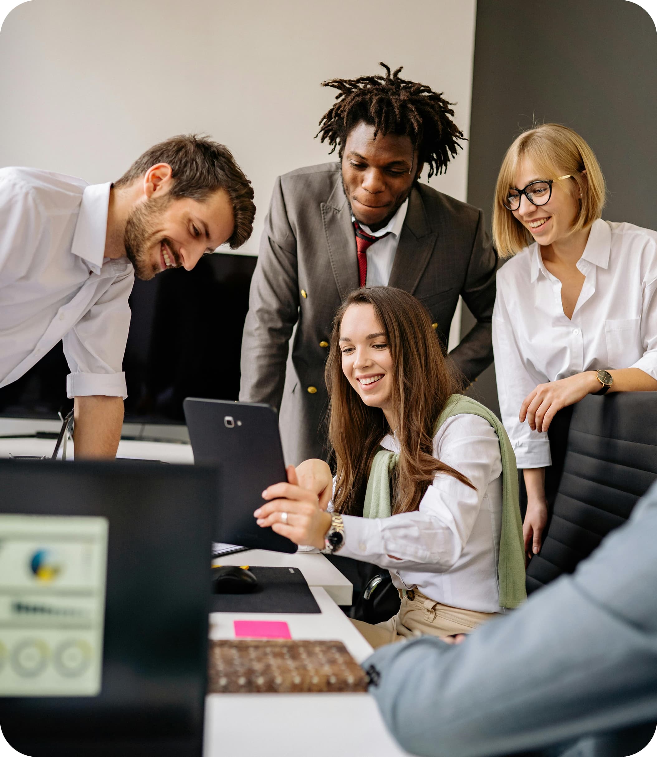 Team collaborating around a laptop